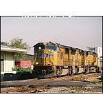 Elements of 4 railroads in 1 photo: W&A Depot, Southern Caboose, UP Locomotive pulling a CSX #X144 Intermodel train.